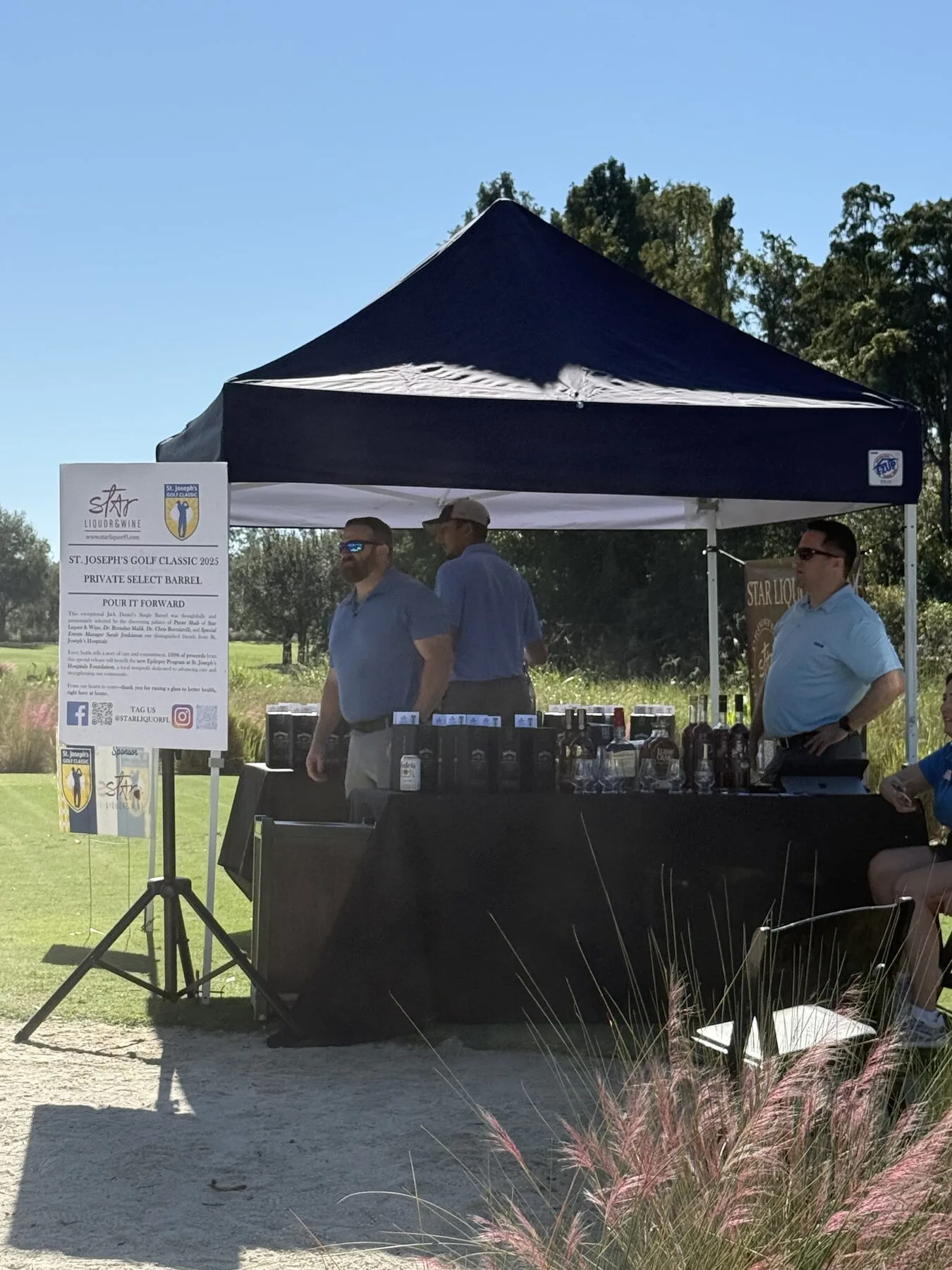 Pour It Forward bottles on the Star Liquor table at the 2025 Golf Classic