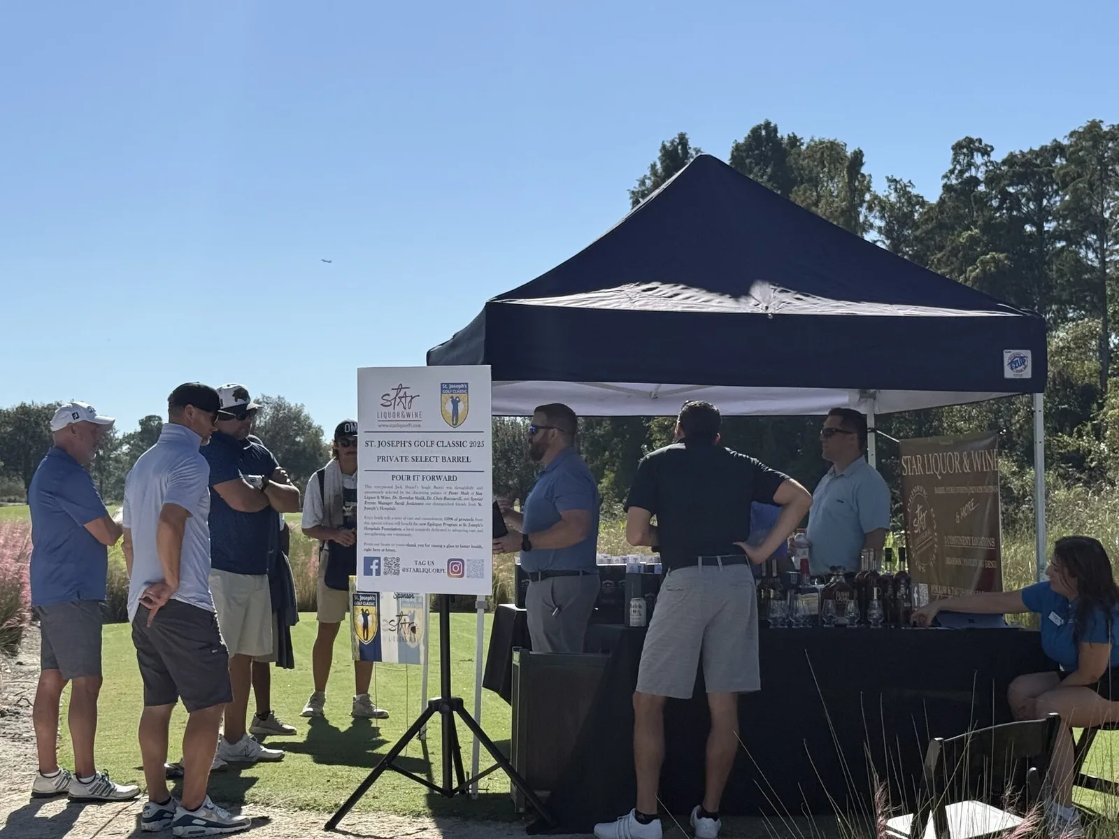 The Star Liquor tent at the 2025 St. Joseph's Golf Classic with the Pour It Forward sign